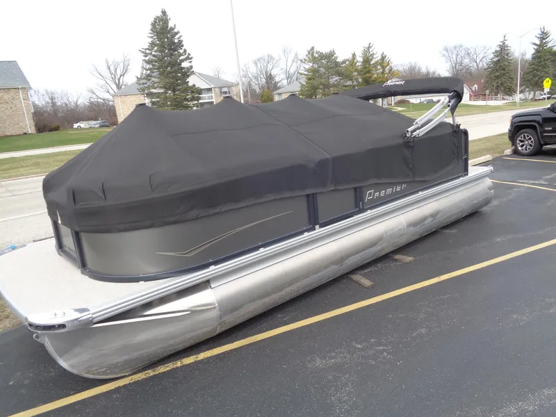 Slide: The Image of 2022 Premier 210 Sunspree pontoon boat with black cover in parking lot. - 20