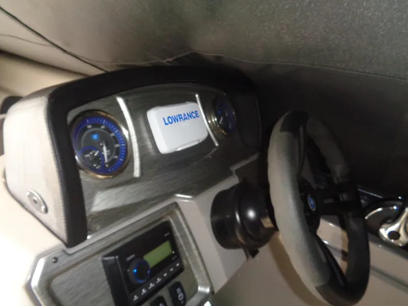 Slide: The Image of Dashboard of 2022 Premier 210 Sunspree boat with Lowrance display and steering wheel. - 29