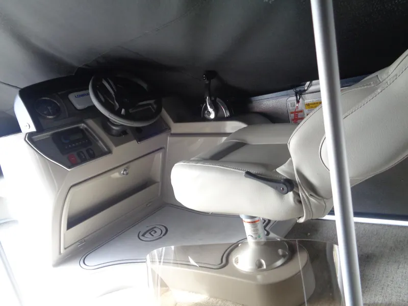Slide: The Image of Interior of 2022 Premier 210 Sunspree boat with steering wheel and captain's chair. - 32