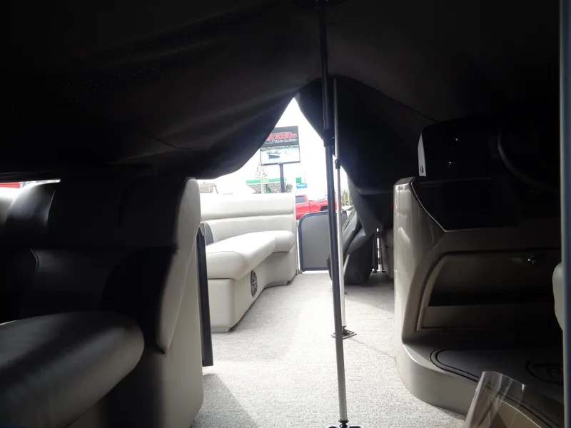 Slide: The Image of Interior view of 2022 Premier 210 Sunspree pontoon boat with covered seating area. - 33