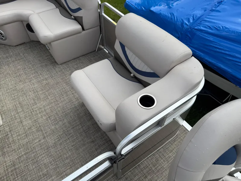 Slide: The Image of 2016 Apex Marine Qwest Adventure 7516 pontoon boat interior with cushioned seating and cup holder. - 13