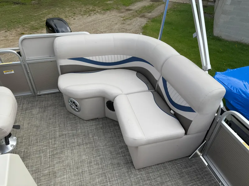 Slide: The Image of 2016 Apex Marine Qwest Adventure 7516 pontoon boat with cushioned seating and stylish interior design. - 16
