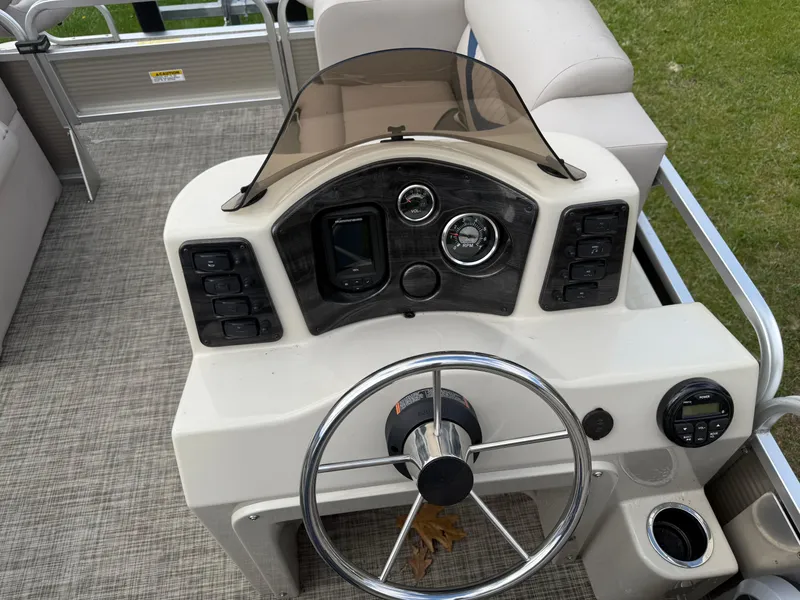 Slide: The Image of 2016 Apex Marine Qwest Adventure 7516 boat dashboard with steering wheel and controls. - 17