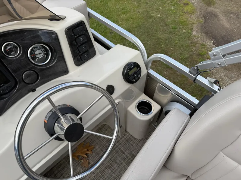 Slide: The Image of Steering console of 2016 Apex Marine Qwest Adventure 7516 pontoon boat with gauges and controls. - 18