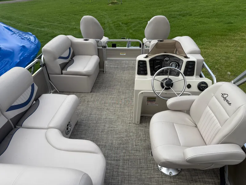 Slide: The Image of 2016 Apex Marine Qwest Adventure 7516 pontoon boat interior with plush seating and steering console. - 20
