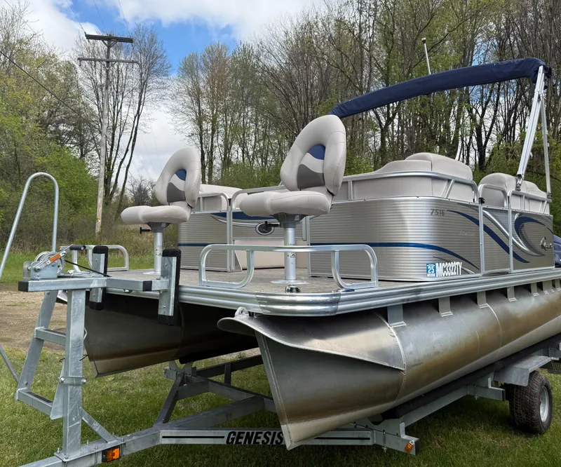 Slide: The Image of 2016 Apex Marine Qwest Adventure 7516 pontoon boat on trailer, surrounded by trees. - 4