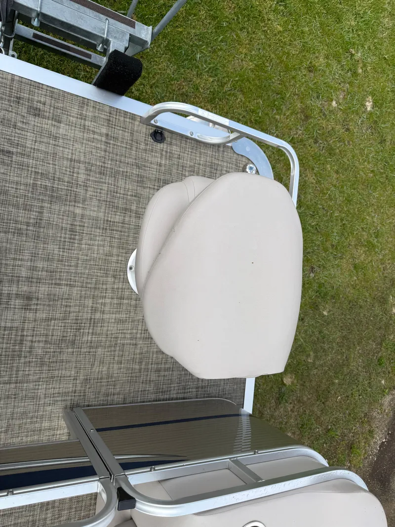 Slide: The Image of 2016 Apex Marine Qwest Adventure 7516 boat seat on deck, grassy background. - 8