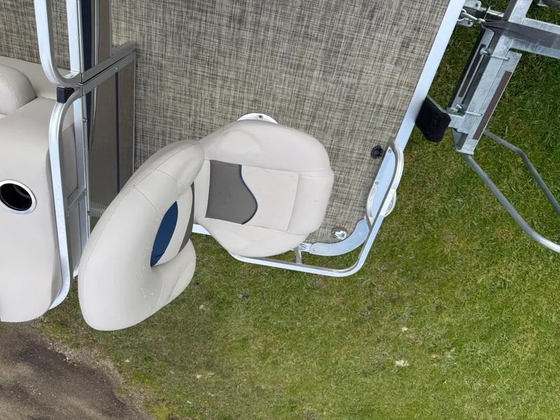 Slide: The Image of 2016 Apex Marine Qwest Adventure 7516 boat seats on grassy shore. - 9