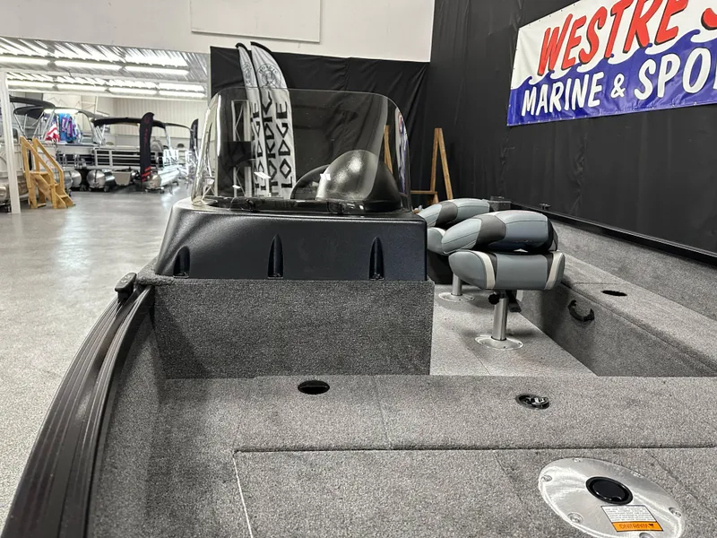 Slide: The Image of 2024 Alumacraft Classic 165 SC boat dashboard with steering wheel and control panel. - 12