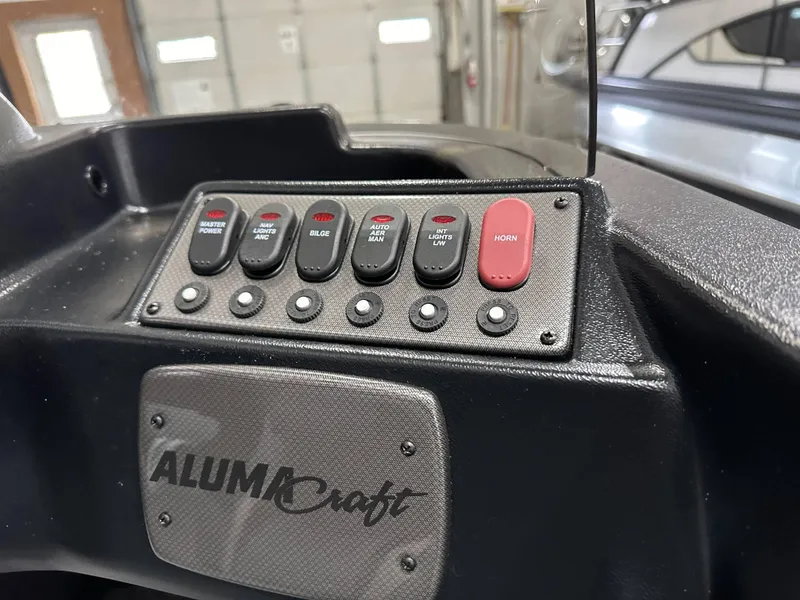 Slide: The Image of 2024 Alumacraft Classic 165 SC boat interior with steering console and seating. - 15