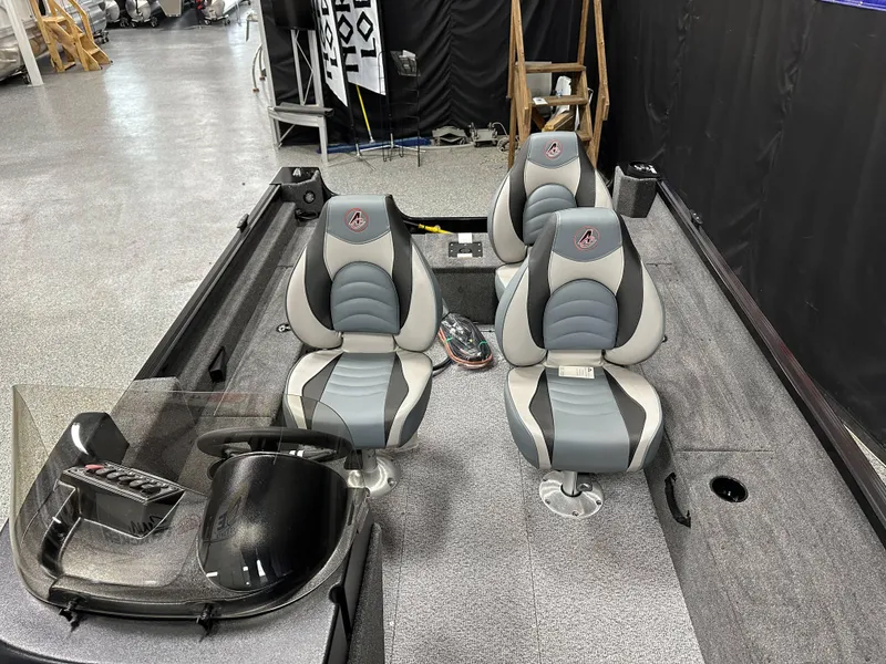 Slide: The Image of 2024 Alumacraft Classic 165 SC boat interior with storage compartment and seating. - 18