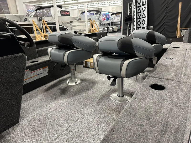 Slide: The Image of 2024 Alumacraft Classic 165 SC boat interior with seating and wiring components. - 19