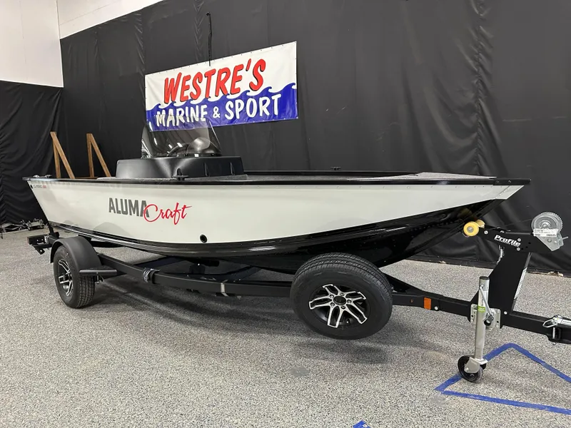 Slide: The Image of 2024 Alumacraft Classic 165 SC boat on trailer in showroom. - 2
