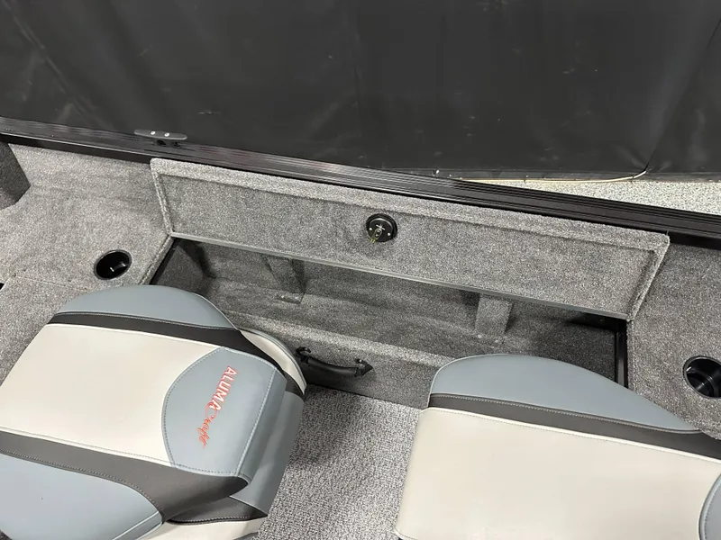 Slide: The Image of 2024 Alumacraft Classic 165 SC interior with seating and storage compartments. - 20