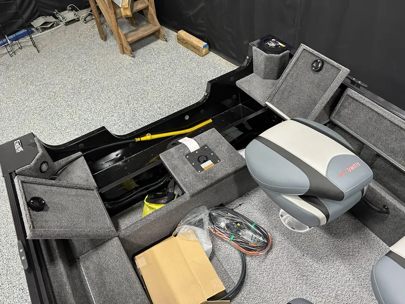 Slide: The Image of 2024 Alumacraft Classic 165 SC boat interior with seating and steering console. - 22