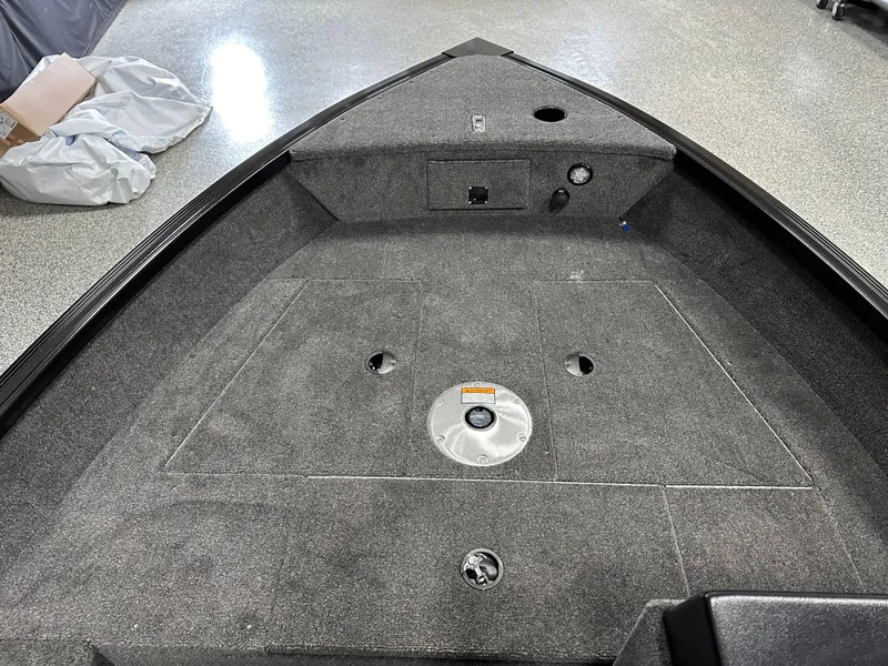 Slide: The Image of 2024 Alumacraft Classic 165 SC boat interior with open storage compartments. - 6