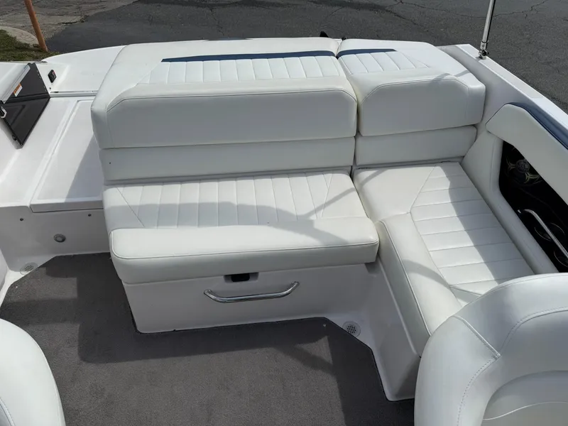 Slide: The Image of 2012 Regal 2000 Bowrider interior with white leather seating and storage compartment. - 13