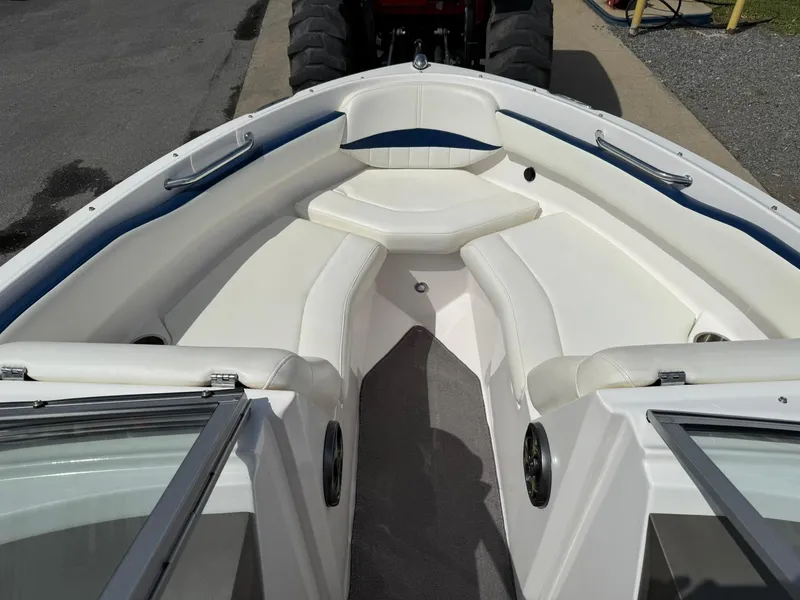 Slide: The Image of 2012 Regal 2000 Bowrider boat interior with white seating and blue accents. - 19