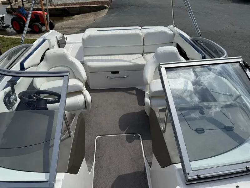 Slide: The Image of 2012 Regal 2000 Bowrider boat interior with white seating and open windshield. - 20