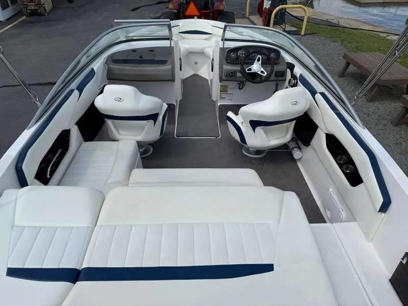 Slide: The Image of 2012 Regal 2000 Bowrider interior with white and blue seating, steering wheel, and dashboard. - 7