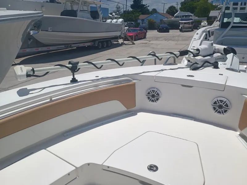 Slide: The Image of 2025 Regulator 30XO boat deck with Garmin equipment, docked in a marina. - 10