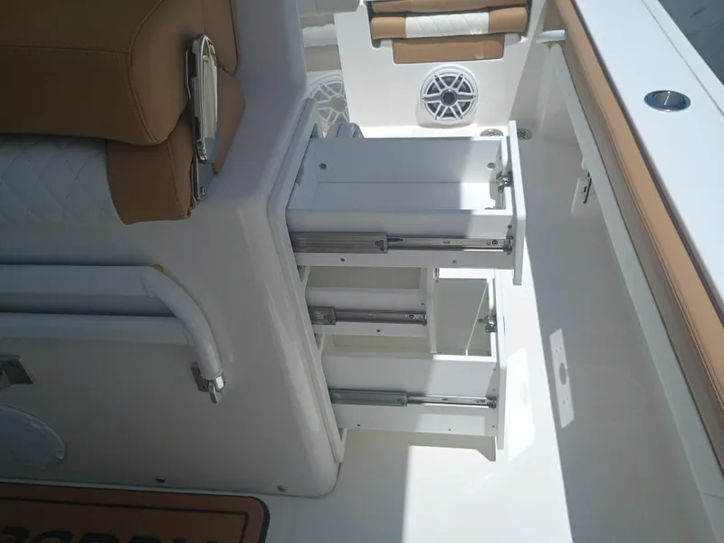 Slide: The Image of 2025 Regulator 30XO boat interior with open storage compartments and seating. - 12