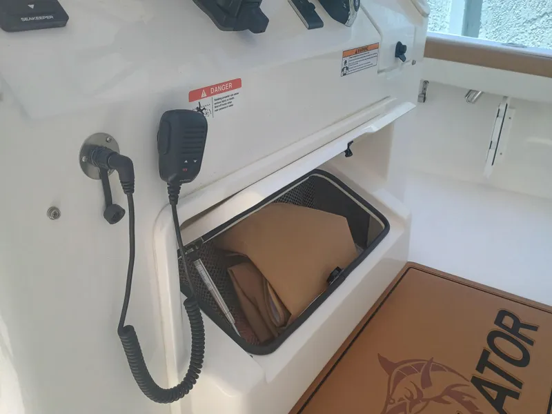 Slide: The Image of 2025 Regulator 30XO boat interior with storage compartment and communication device. - 13