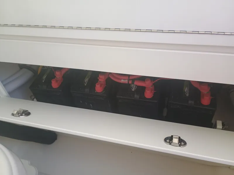 Slide: The Image of Battery compartment of 2025 Regulator 30XO boat with red terminal connections. - 17