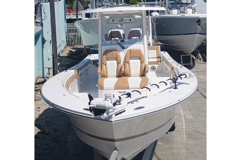 Slide: The Image of 2025 Regulator 30XO boat with dual seats and Garmin equipment, docked outdoors. - 2