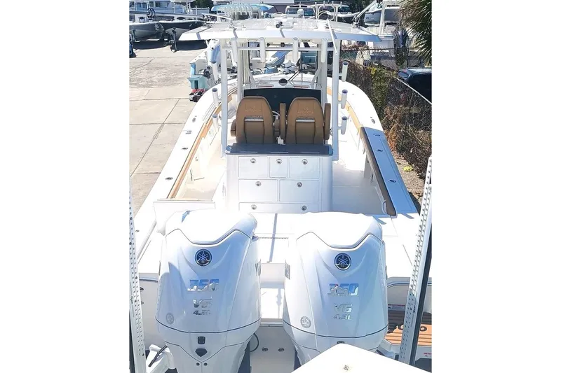 Slide: The Image of 2025 Regulator 30XO boat with dual Yamaha 350 engines, docked at a marina. - 3