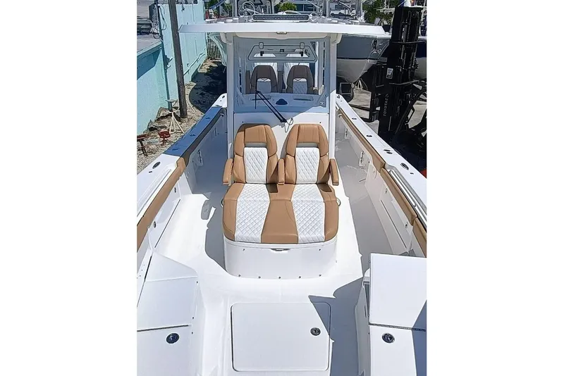 Slide: The Image of 2025 Regulator 30XO boat with tan and white seating, docked outdoors. - 6