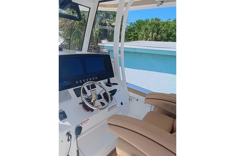 Slide: The Image of 2025 Regulator 30XO boat cockpit with modern steering and dual screens. - 7
