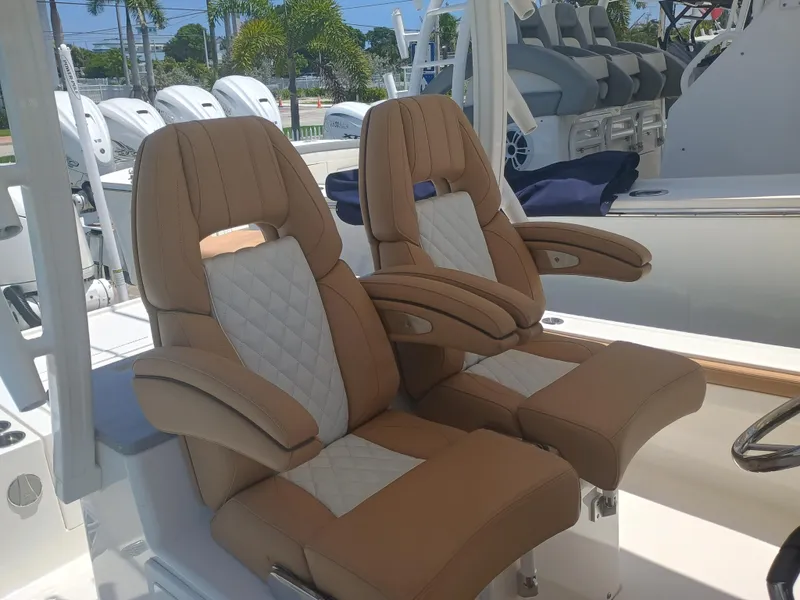 Slide: The Image of Luxurious seating on 2025 Regulator 30XO boat, featuring tan and white upholstery. - 8