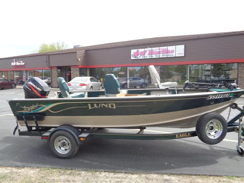 Slide: The Image of 1999 Lund 1650 Angler boat on trailer, parked outside a building. - 10