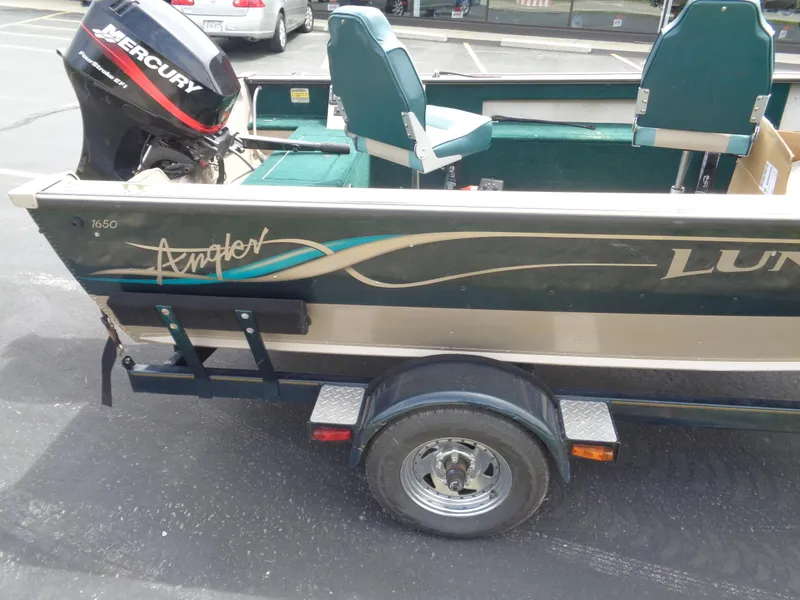 Slide: The Image of 1999 Lund 1650 Angler boat with Mercury outboard motor on trailer. - 11