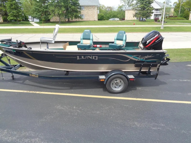 Slide: The Image of 1999 Lund 1650 Angler boat with trailer and Mercury outboard motor. - 13