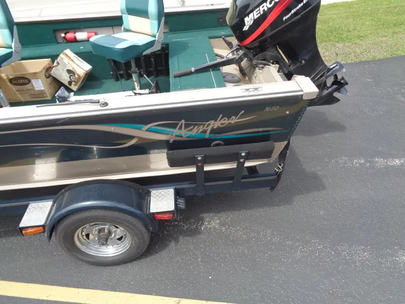 Slide: The Image of 1999 Lund 1650 Angler boat with trailer and Mercury outboard motor. - 5