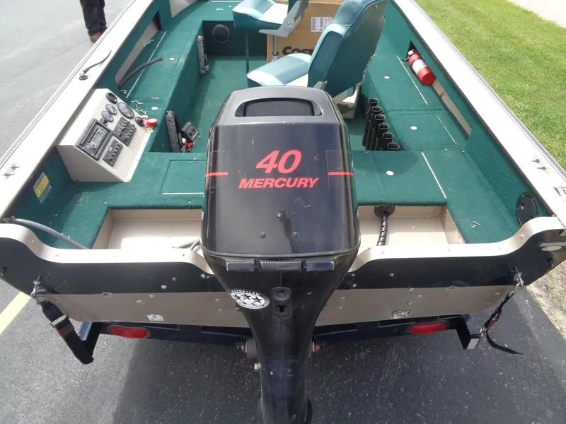 Slide: The Image of 1999 Lund 1650 Angler boat with 40 Mercury outboard motor, green interior, and control panel. - 8