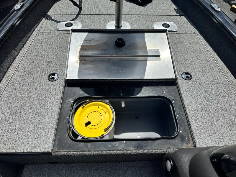 Slide: The Image of 2023 Tracker 175 Pro Team boat interior with storage compartment and yellow reel. - 14