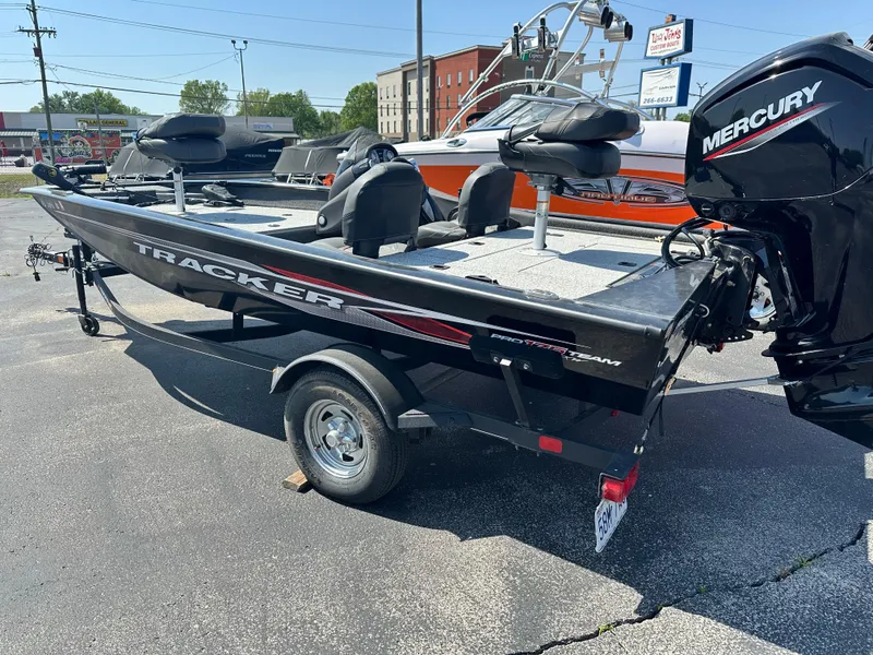 Slide: The Image of 2023 Tracker 175 Pro Team boat with Mercury engine on display in a parking lot. - 3