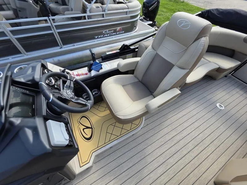 Slide: The Image of Luxurious 2025 Veranda VR22RC XL Tri-Toon boat interior with plush seating and modern steering console. - 14