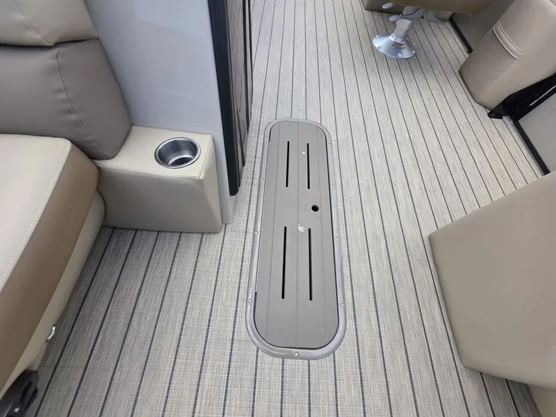 Slide: The Image of 2025 Veranda VR22RC XL Tri-Toon interior with beige seating and striped flooring. - 19