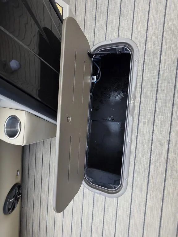 Slide: The Image of 2025 Veranda VR22RC XL Tri-Toon storage compartment with open hatch on deck. - 20