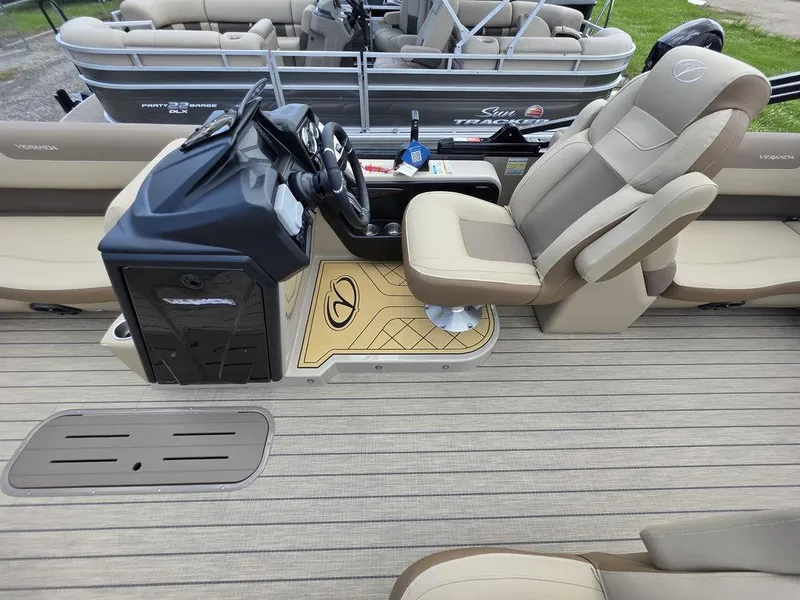 Slide: The Image of 2025 Veranda VR22RC XL Tri-Toon boat interior with beige seating and modern helm. - 21