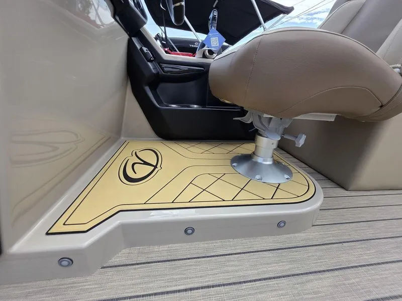 Slide: The Image of Captain's seat and console of 2025 Veranda VR22RC XL Tri-Toon boat, featuring stylish flooring. - 23