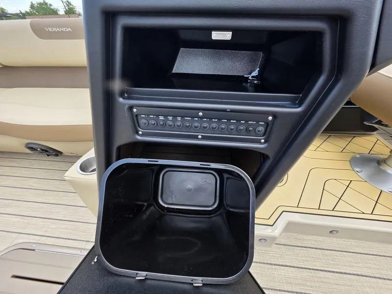 Slide: The Image of Control panel and storage compartment on 2025 Veranda VR22RC XL Tri-Toon boat. - 25
