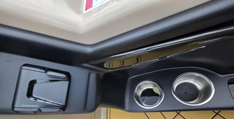 Slide: The Image of Interior view of 2025 Veranda VR22RC XL Tri-Toon with cup holders and storage compartment. - 27