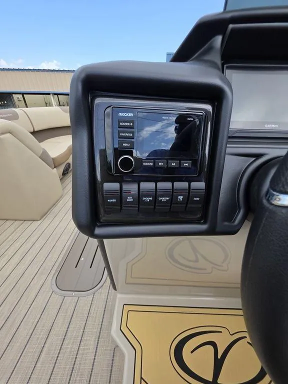 Slide: The Image of 2025 Veranda VR22RC XL Tri-Toon dashboard with control panel and seating area. - 29