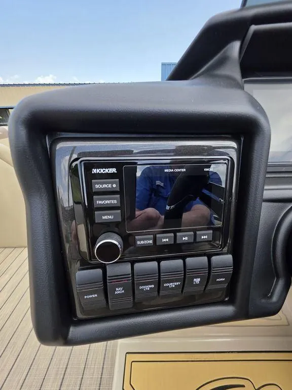 Slide: The Image of 2025 Veranda VR22RC XL Tri-Toon dashboard with Kicker media center controls. - 31