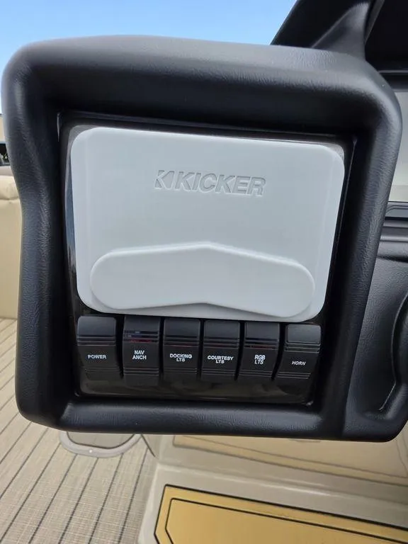 Slide: The Image of 2025 Veranda VR22RC XL Tri-Toon dashboard with Kicker audio system and control switches. - 34